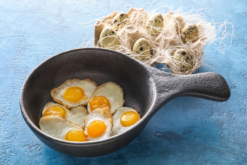 cooked quail eggs in frying pan