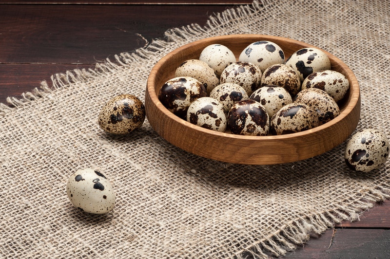 quail eggs on wooden plate